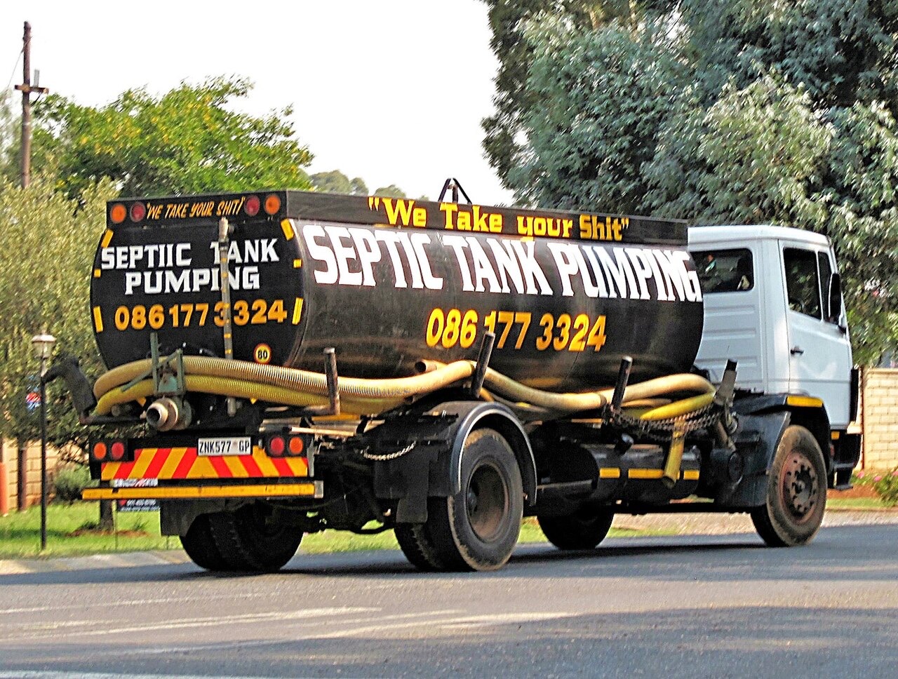 Septic pumping hose at a tank opening